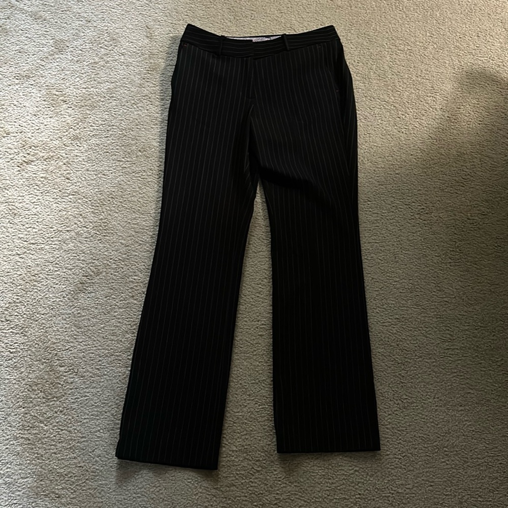 Black suit pants. Striped pattern.
